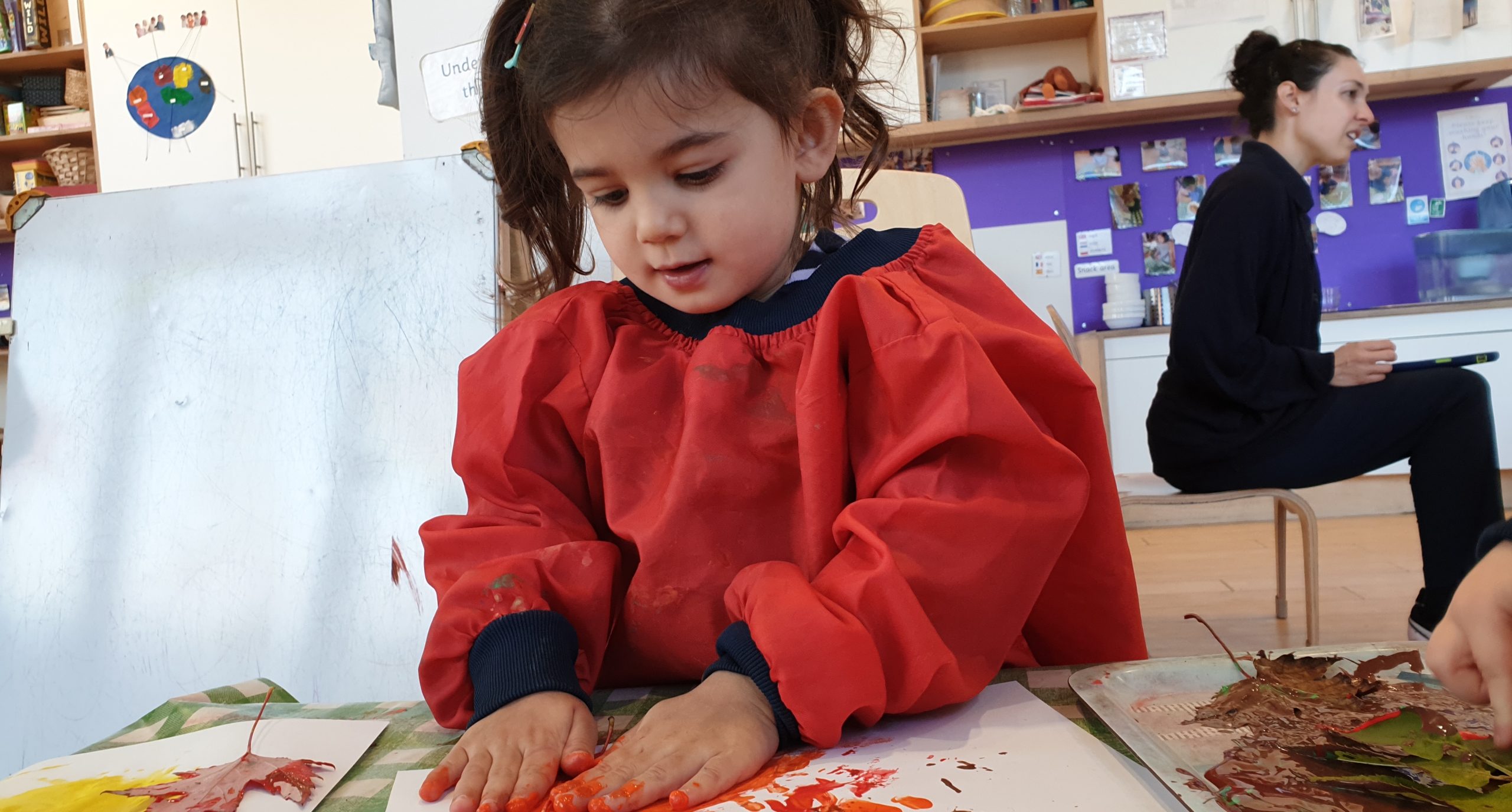 a Child Enjoying Art at the Gower School Independent Nursery.