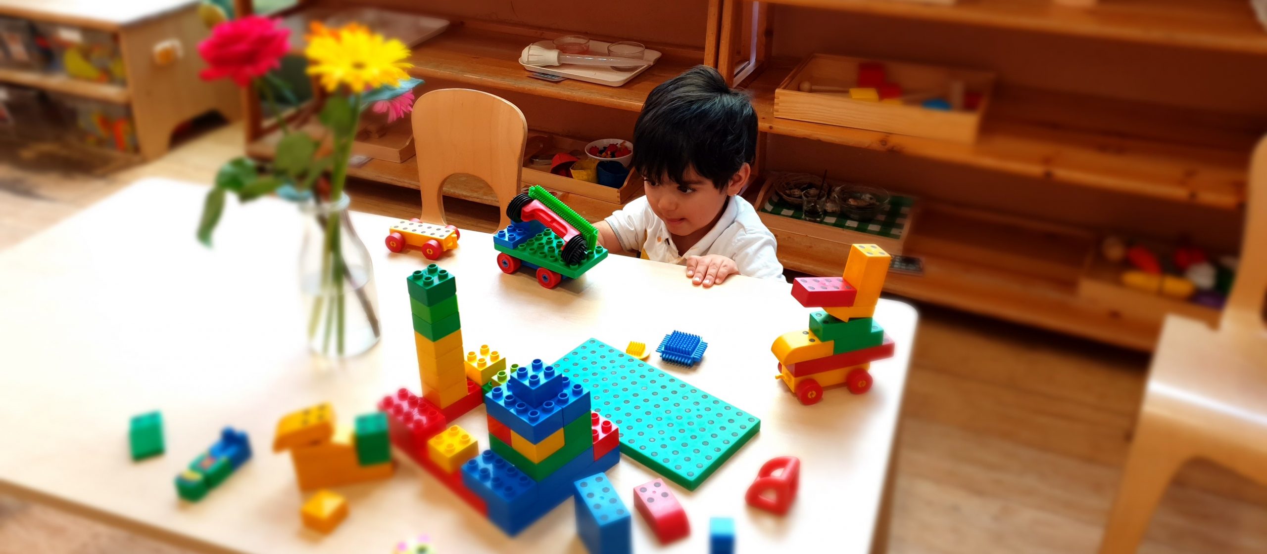 a Curious Child Engages with a Toy Car at the Gower School's private nursery in London.