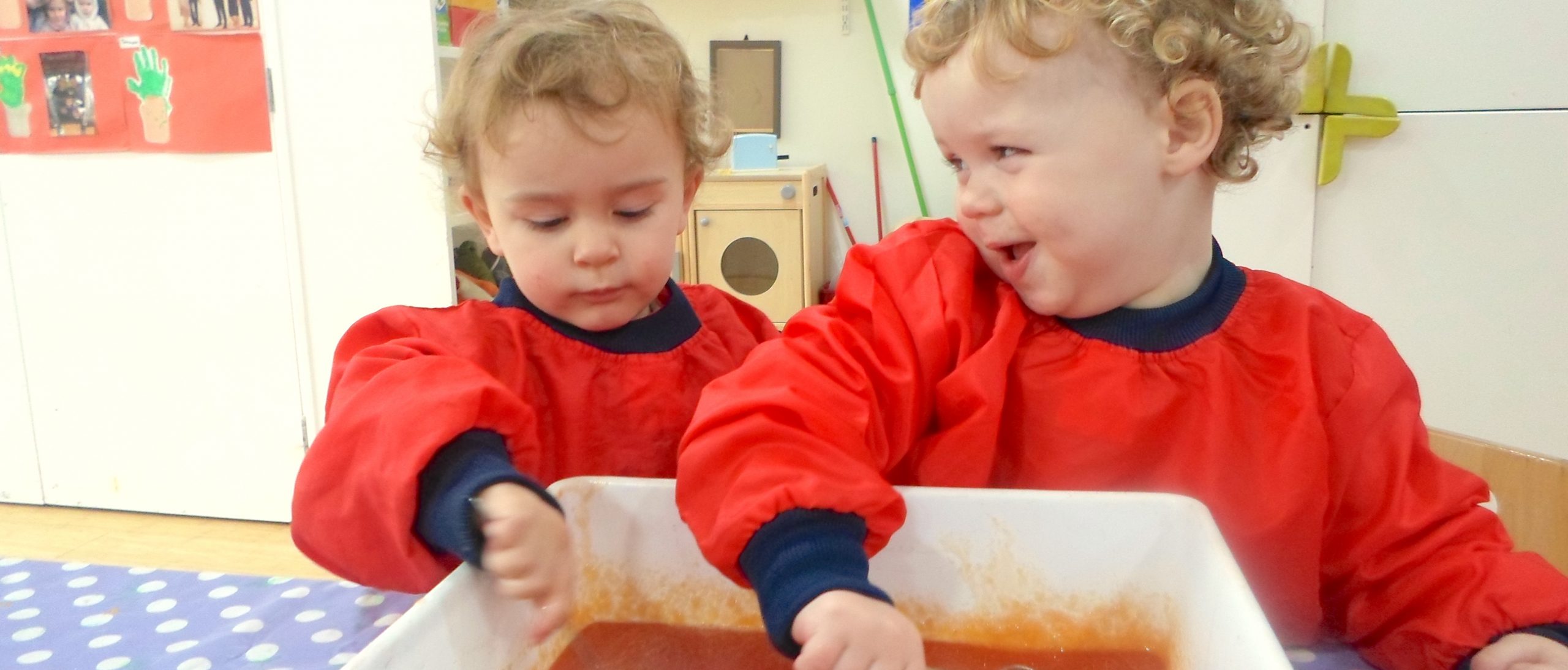 Two Happy Children Engageing in Messy Play Activities in the Gower School Private Nursery.