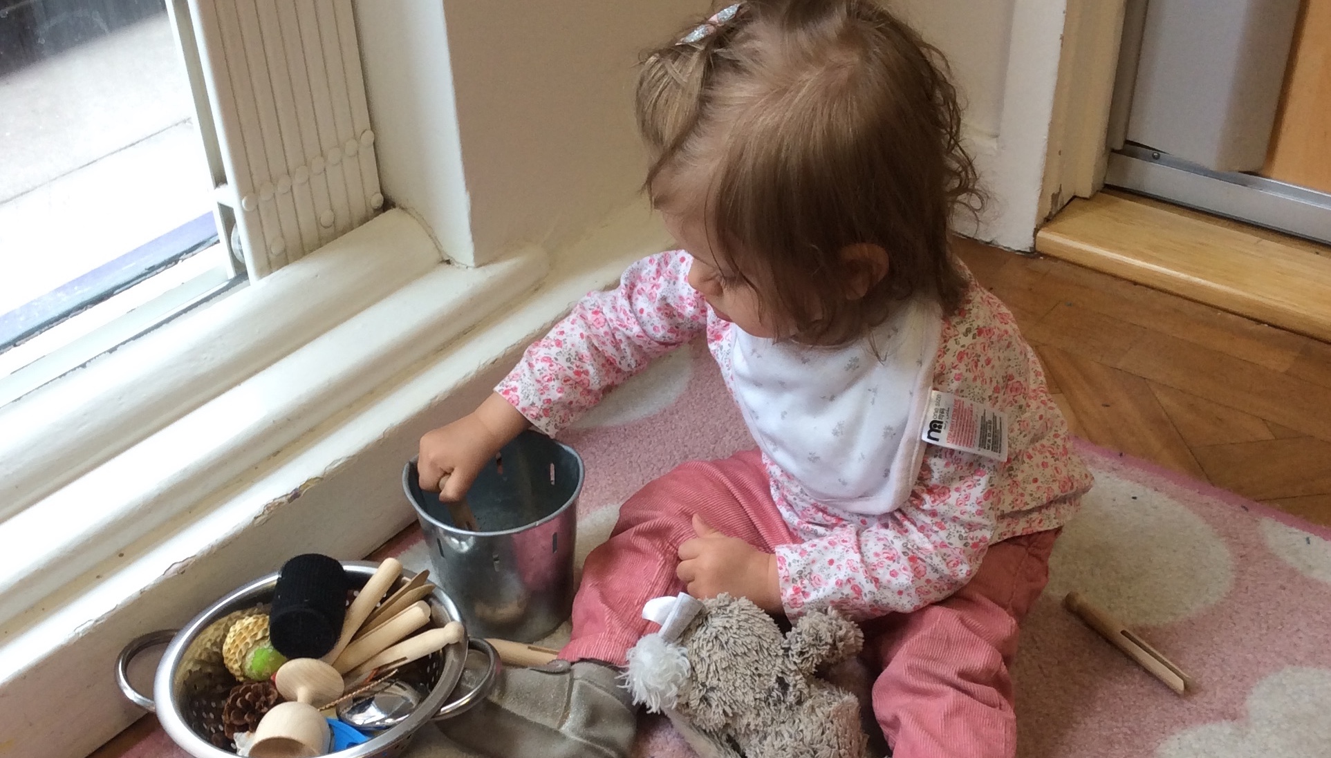 a Baby Explores a Treasure Basket in the Gower School's Montessori Nursery in Islington,London.