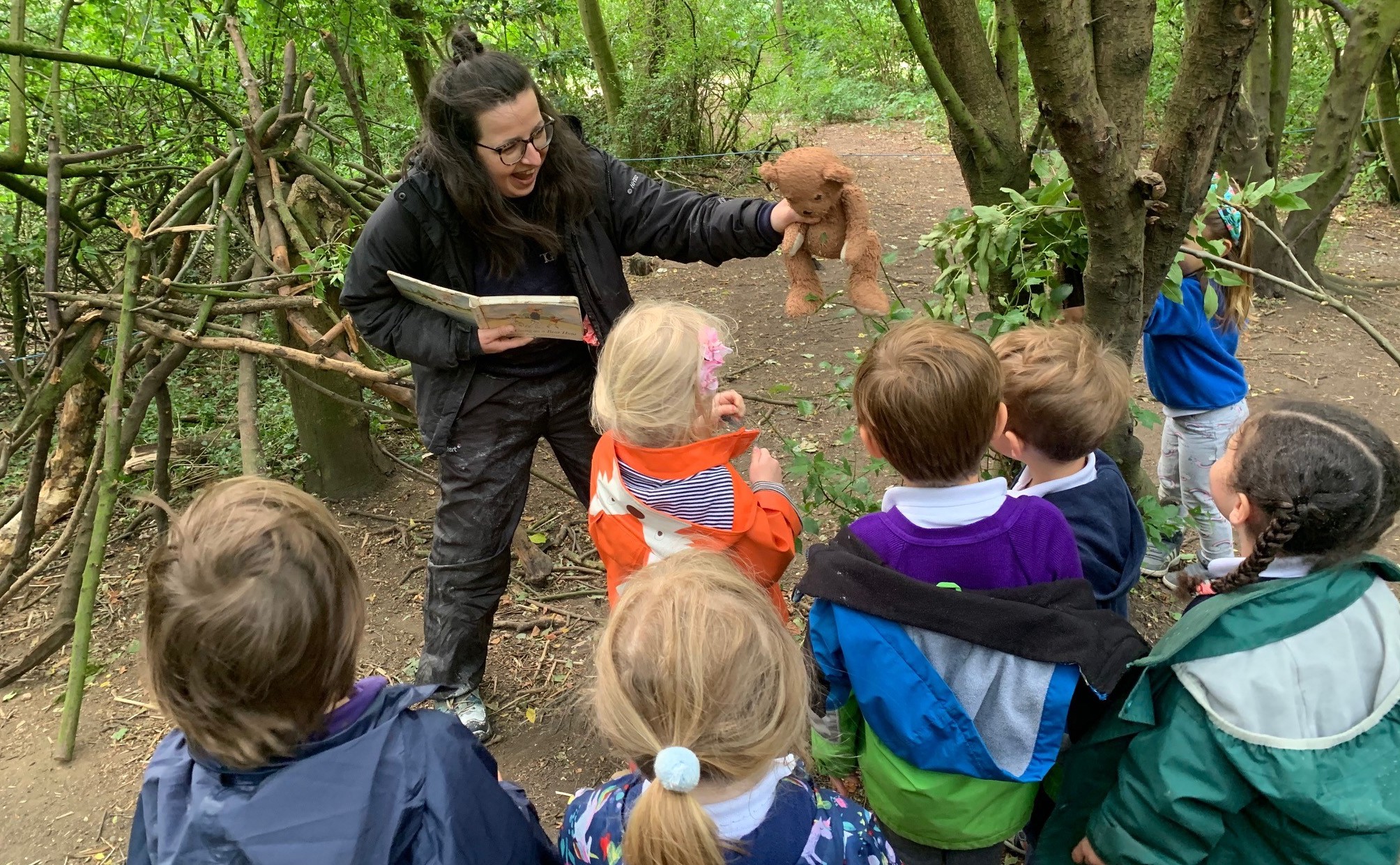 Children Enjoying Forest School Storytelling in the Gower School, a Montessori Nursery in London.