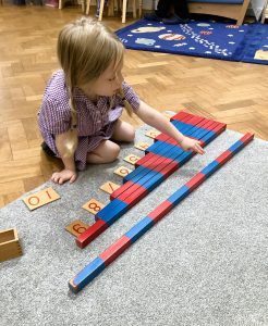 a Girl Counts with Counting Sticks at the Gower School Montessori Nursery, Islington. 