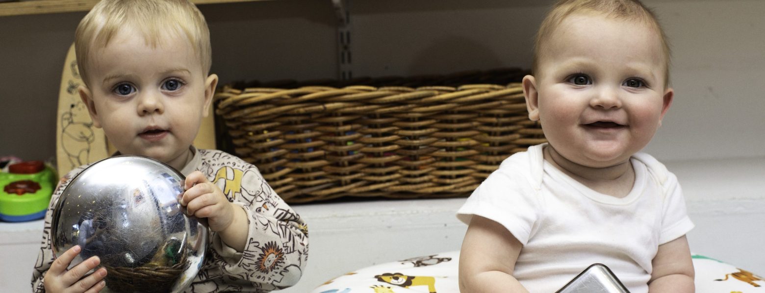 Two Babies with a Treasure Basket.