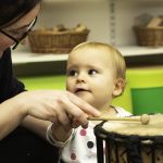 child looking at a drum