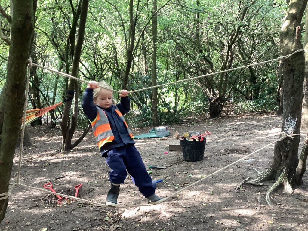 Child balancing onto a piece of rope
