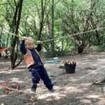 Child balancing onto a piece of rope