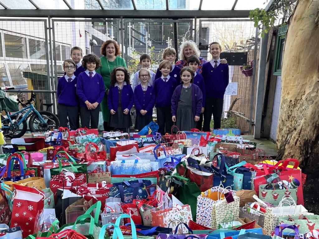 students stood by some gifts